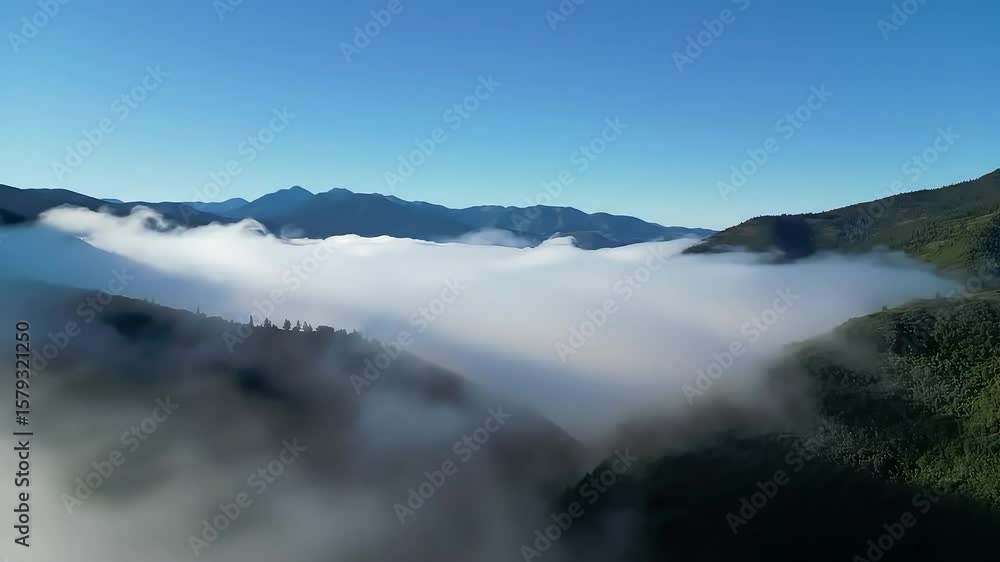 Aerial View of Mountain Valley Covered in Fog and Clouds Aerial View of Mountain Valley Covered in Fog and Clouds