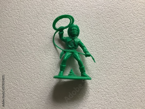 a green plastic toy cowboy
