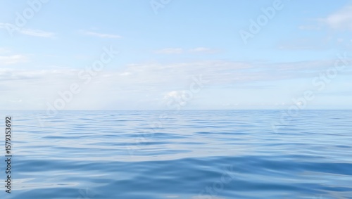 Serene blue ocean horizon under a softly clouded sky with gentle ripples on the water surface