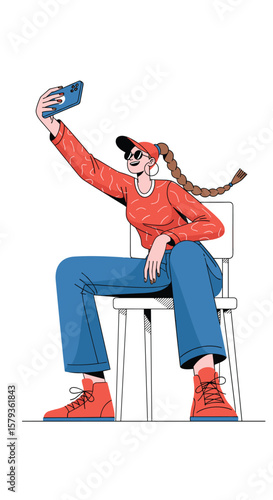 Young woman captures self portrait while sitting on chair outdoors