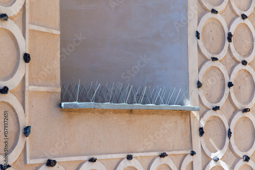 metal spikes placed in the window to prevent birds from roosting and staining buildings with their droppings