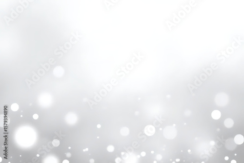 Abstract white and gray bokeh background with blurred glowing circles and soft light effects for design elements