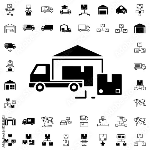 A delivery truck is parked outside a warehouse