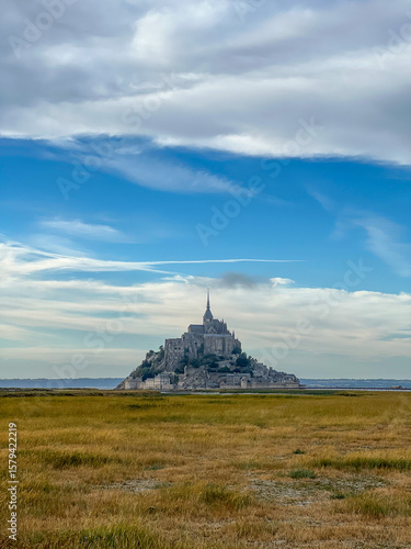 Wallpaper Mural Mont-Saint-Michel castle in the early morning under blue sky with clouds, Normandy, France  Torontodigital.ca