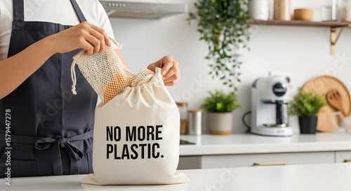 A person fills a reusable cotton bag with mesh bags in the kitchen, a visual statement against single use plastic and advocating for zero waste lifestyle.