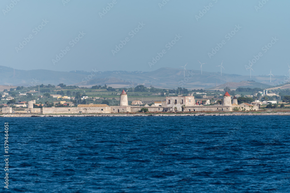 View on Saline di Trapani e Paceco Culcasi, brackish lagoon and nature reserve on Sicily, Italy, unique ecosystem with shallow, warm water, salt pans, and ancient windmills. View on Saline di Trapani e Paceco Culcasi, brackish lagoon and nature reserve on Sicily, Italy, unique ecosystem with shallow, warm water, salt pans, and ancient windmills.