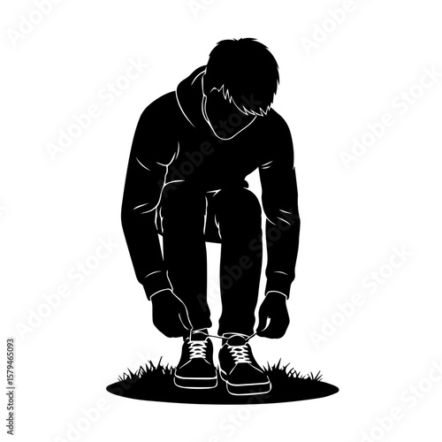 Young man kneeling and tying shoelaces on grass outdoors  