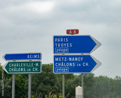 Canvas Print Driving in summer on highway and road signs direction to Reims and other French