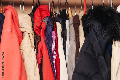 Wallpaper Mural Various jackets hanging on hangers. Colorful winter clothes in wardrobe. Different types of coats and fabrics. Closet full of warm outerwear. Everyday fashion. Storage space in home interior. Torontodigital.ca