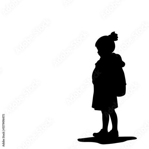 Silhouette of young girl standing alone with backpack in profile  