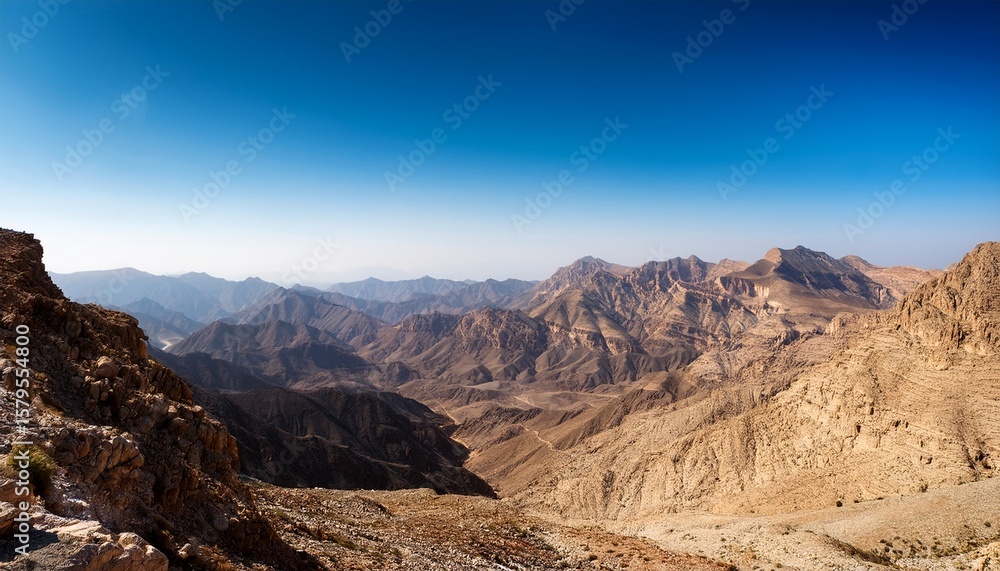 Fototapeta premium explore the stunning mountainous landscapes of oman under a clear blue sky during midday