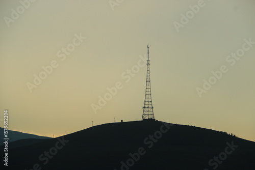 radio antenna silhouette over the mountain