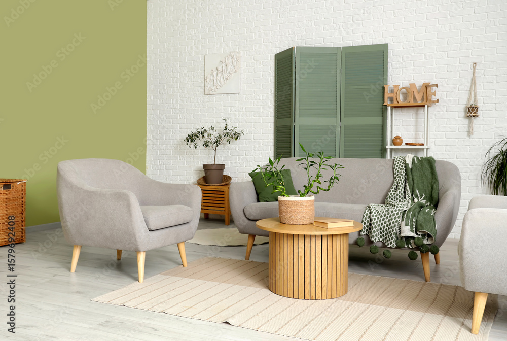 Obraz premium Stylish interior of modern living room with bamboo stems and sofa