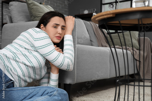 Depressed young woman near ...