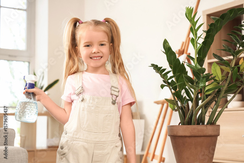 Cute little girl water spra...