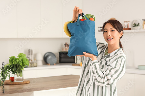 Young Asian woman holding b...