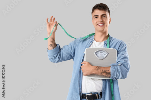 Smiling young man holding w...