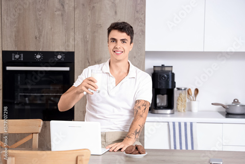 Young man with glass of mil...