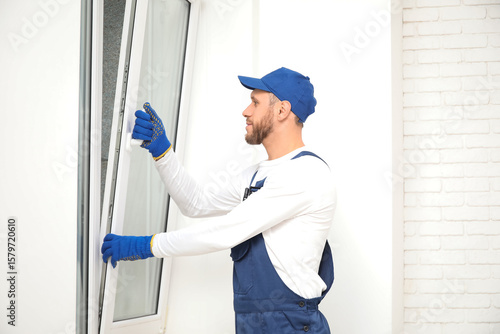 Male worker opening window ...