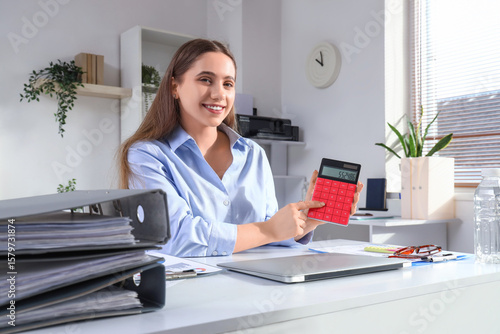 Female accountant with calc...