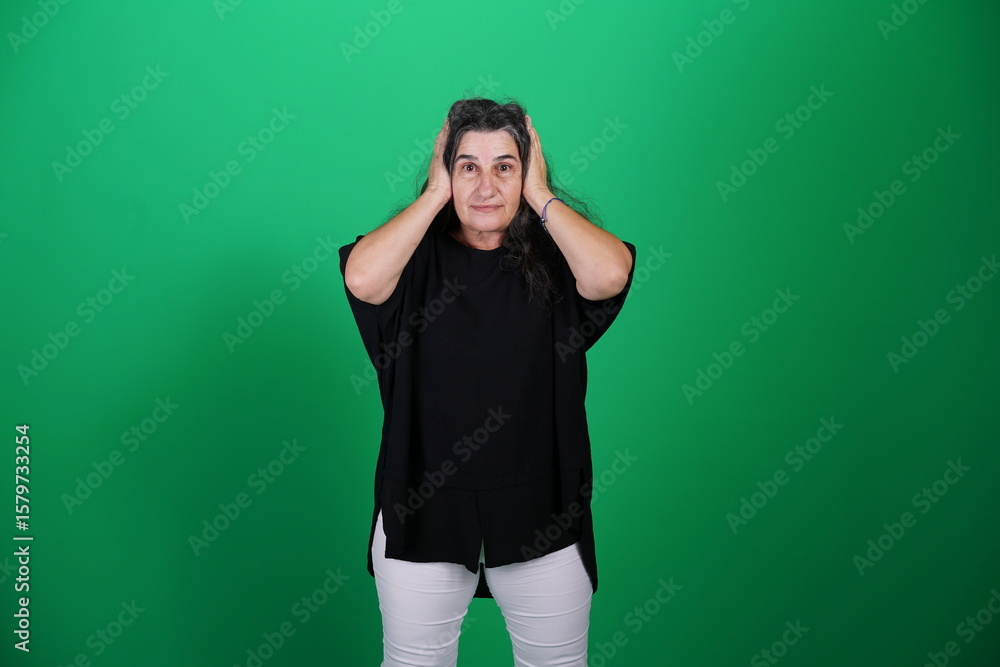 Fototapeta premium Unedited Portrait of Woman’s Face Expressing Various Emotions – Green Studio Background