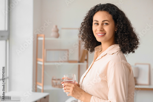 Smiling young woman holding...