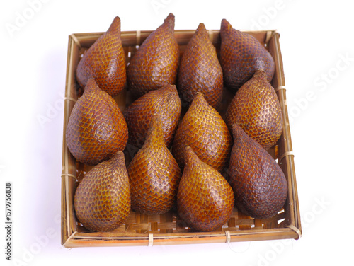 Fresh snakefruit on a bamboo plate isolated on white background, buah salak, salacca zalacca, delicious
