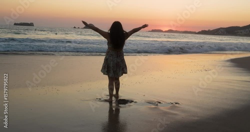 Slow motion of Mexican woman that enjoys Zihuatanejo beach at sunset