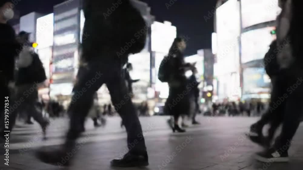 People walking at night on city street crosswalk lights.
People walking at night on city street crosswalk lights.