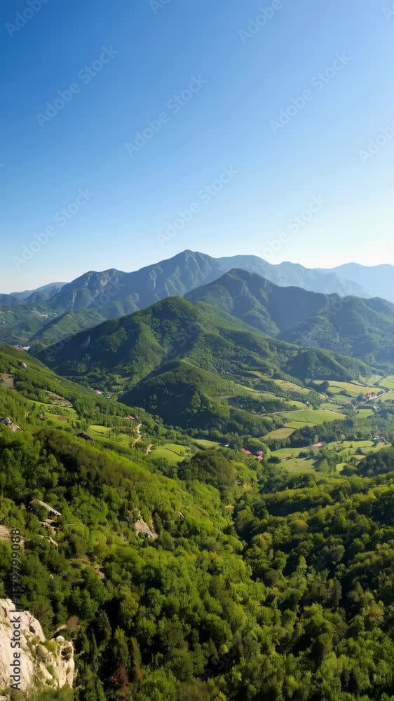 Lush green mountain range landscape under bright blue sky. Scenic view of hills, forests and valleys in the distance on a clear day. Lush green mountain range landscape under bright blue sky. Scenic view of hills, forests and valleys in the distance on a clear day.