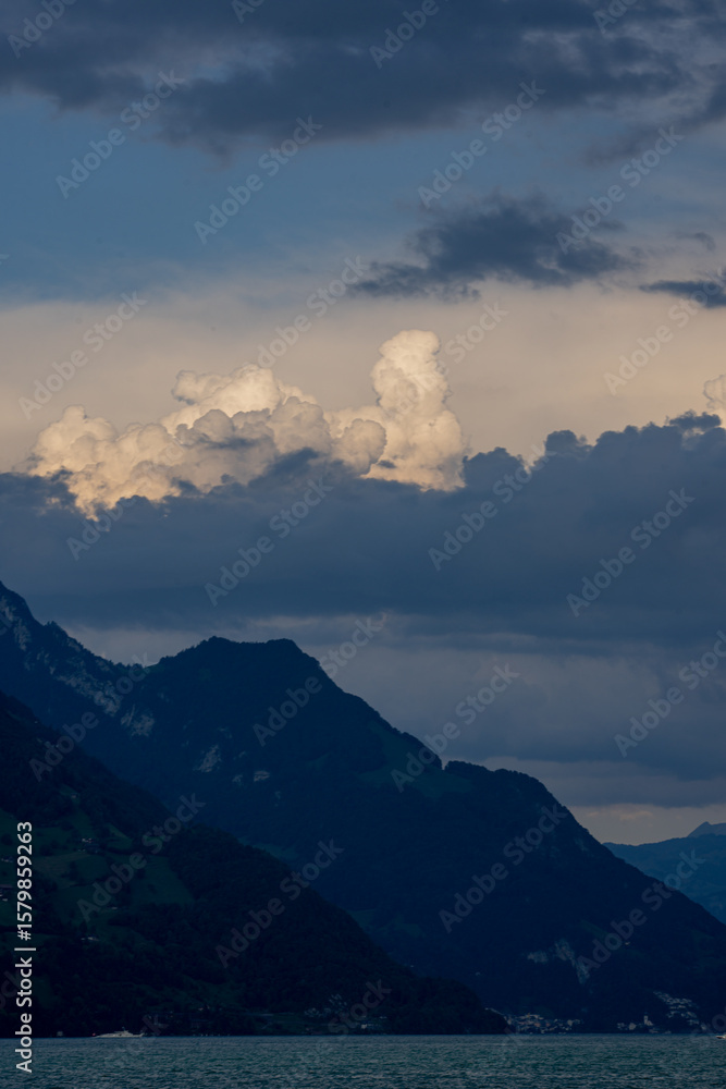 Obraz premium Rural landscape in the Swiss Alps. Lake Lucerne, Switzerland. A view to the lake of Lucerne. Rural landscape. Resort surrounded by swiss Alps mountains on Lake Lucerne, Switzerland.