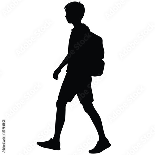 Silhouette of a Boy Walking with Backpack, Wearing Shorts and Sneakers