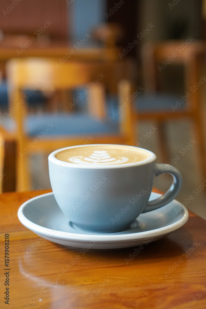 Fototapeta premium Hot Macadamia Latte, Indonesia, captured on July 13, 2025. Creamy espresso with macadamia nut milk, served warm in a ceramic cup on a table for a rich, nutty flavor