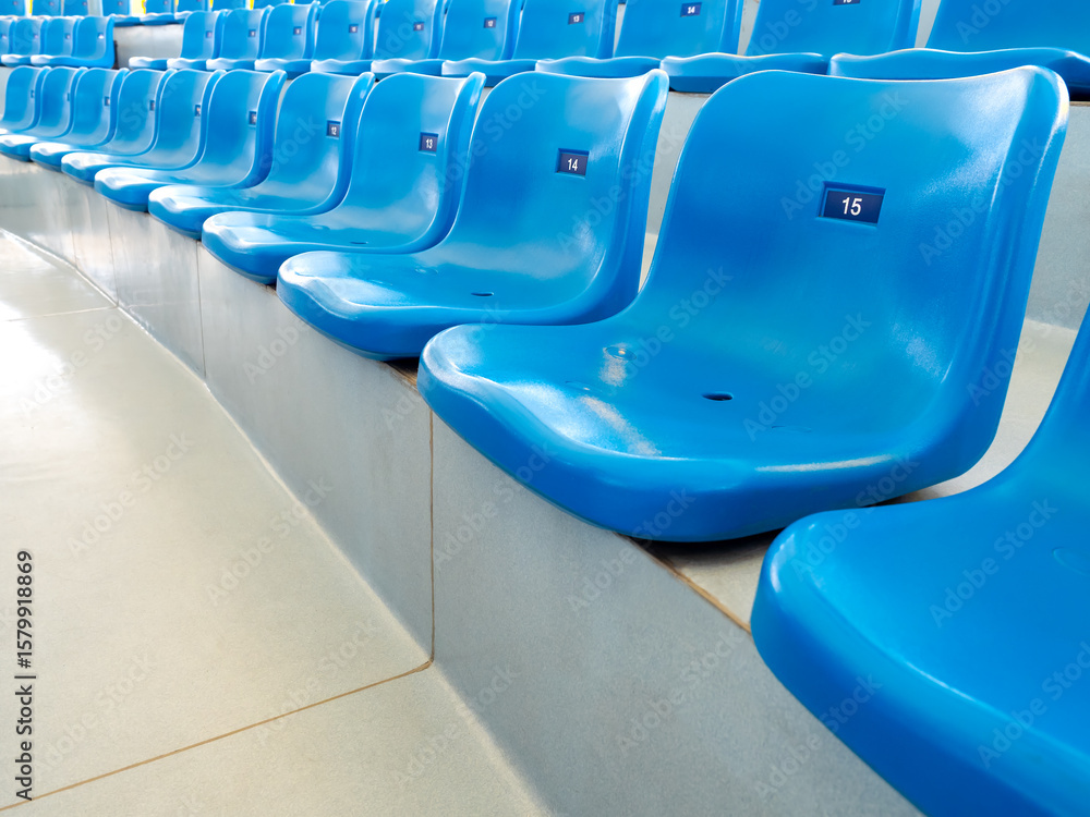 Fototapeta premium Empty blue plastic seats or stadium chairs with numbers in aquarium show or stadium. Rows of seats pattern, on the steps with nobody.
