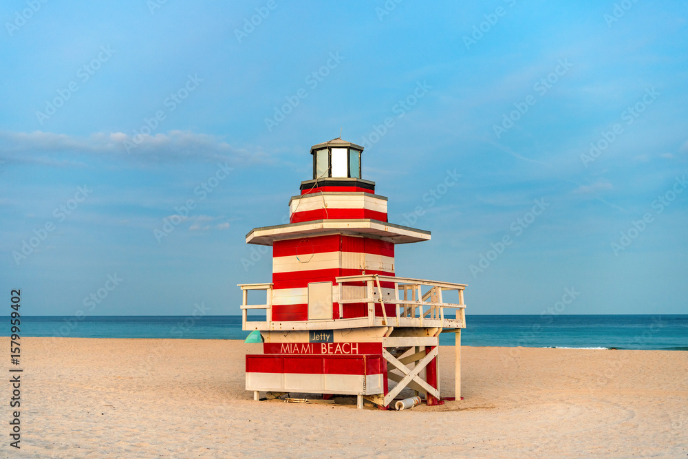 Fototapeta premium Miami Beach pier. Iconic lifeguard tower on Miami Beach. Scenic view of Miami Beach coastline. Famous South Beach lifeguard. Tropical paradise in Miami. Art Deco lifeguard on Miamis shoreline.
