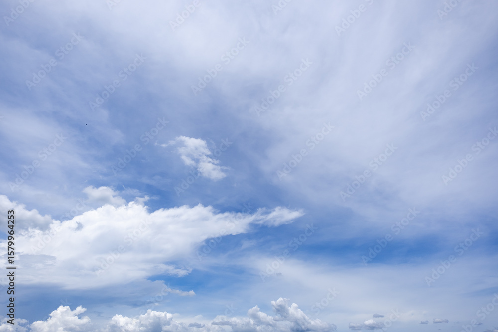 Obraz premium clear blue sky background,clouds with background, Blue sky background with tiny clouds. White fluffy clouds in the blue sky. 