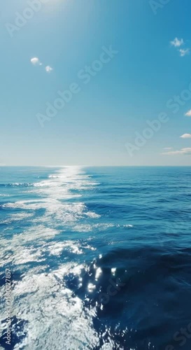 Sparkling ocean surface with blue sky and few clouds serene sea view