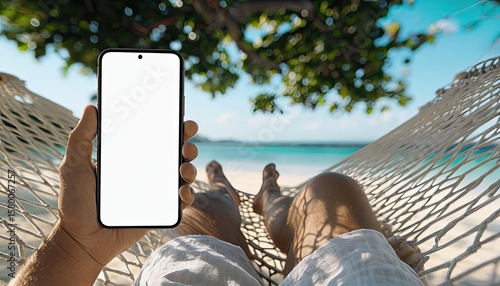 Title: Hand Holding a Blank Smartphone Mockup While Relaxing in a Hammock on the Beach