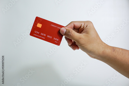 Close up of hand with red credit card isolated on white background. Shopping, finance and people concept