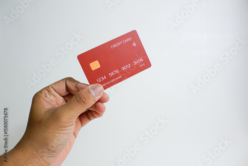 Close up of hand with red credit card isolated on white background. Shopping, finance and people concept