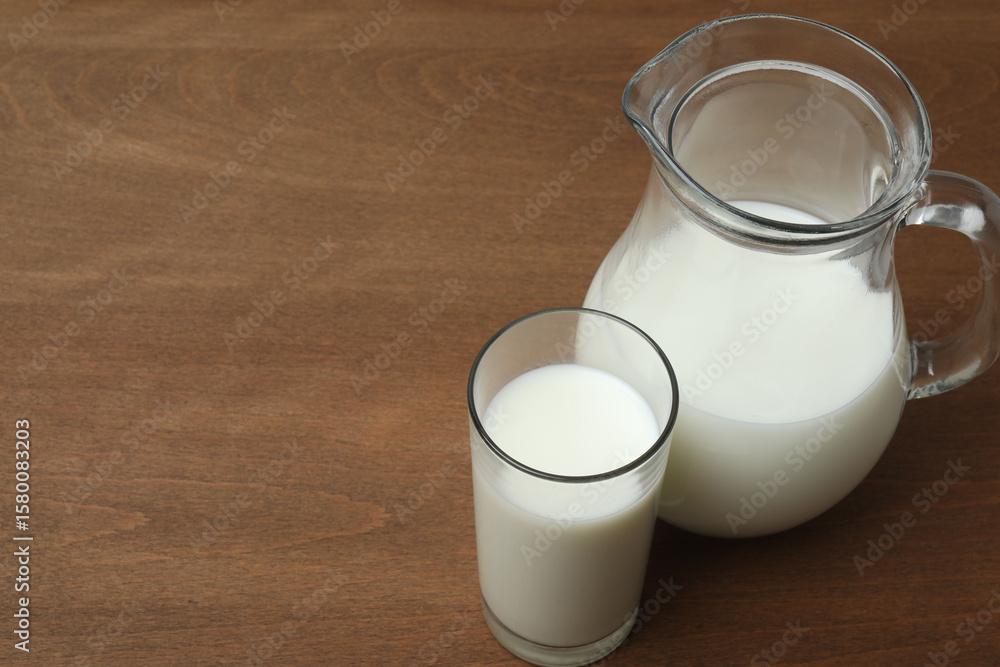 glass and jug with milk on wooden background
glass and jug with milk on wooden background