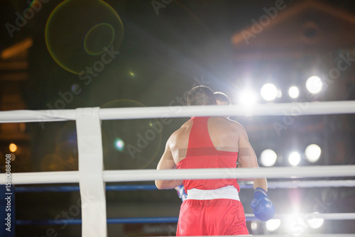 Boxing fight of two athletes in gloves in the ring