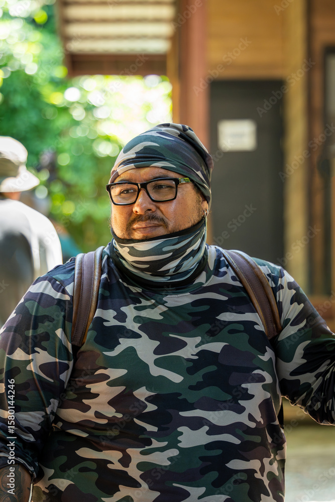 Fototapeta premium Latin tourist in camouflage clothing and hiking backpack in tropical destination of Corcovado, Costa Rica