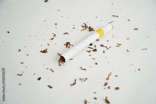 cigarette butt with tobacco on white background