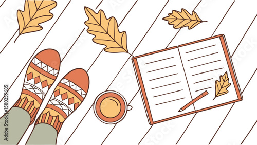Cozy autumn scene with feet in patterned socks a warm cup of coffee an open notebook and fallen oak leaves on a wooden surface