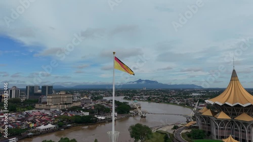 Aerial drone footage Tallest flagpole in Malaysia, and South East Asia. The Tiang Ibu Pertiwi, translated to Pillars of The Motherland, waving Sarawak flag beside Sarawak State building