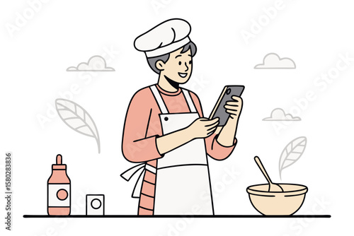 Smiling chef in apron and hat uses smartphone to follow recipe while preparing food in kitchen