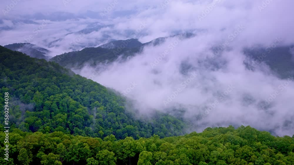 Cloudlike mist hugs the ridges in this Smoky Mountain drone shot. Cloudlike mist hugs the ridges in this Smoky Mountain drone shot.