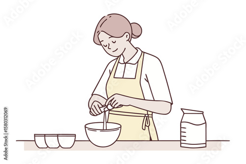 A woman wearing an apron carefully adds an ingredient to a bowl while preparing food in a kitchen setting