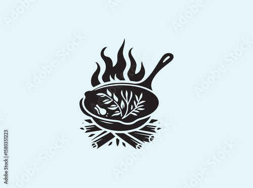 Outdoor flame cooking with black cast iron pan